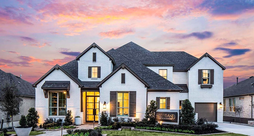 Modern White Brick House at Sunset with Well-Manicured Gardens
